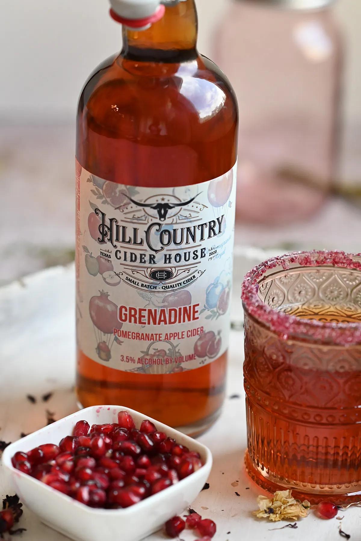 Grenadine cider bottle styled with fruit