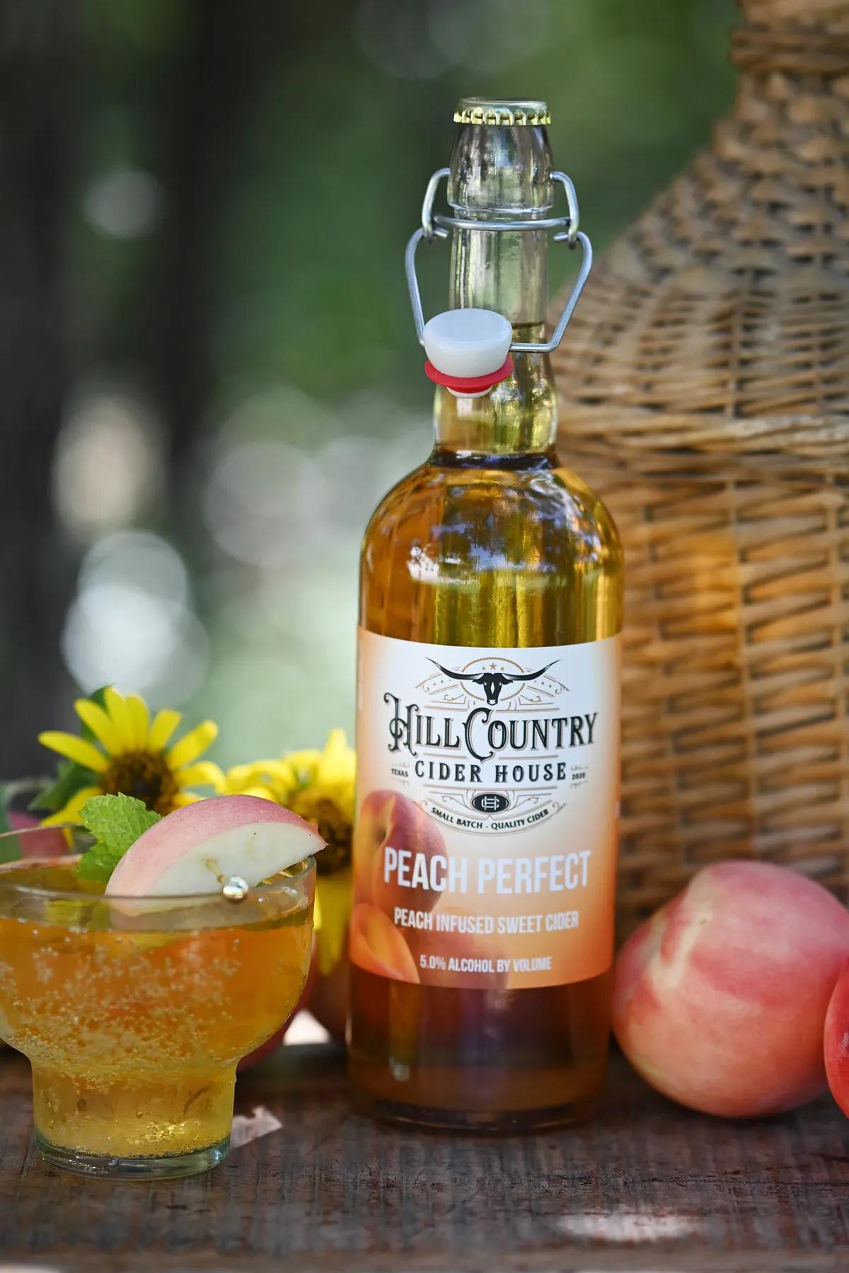 Peach cider bottle with fresh peaches