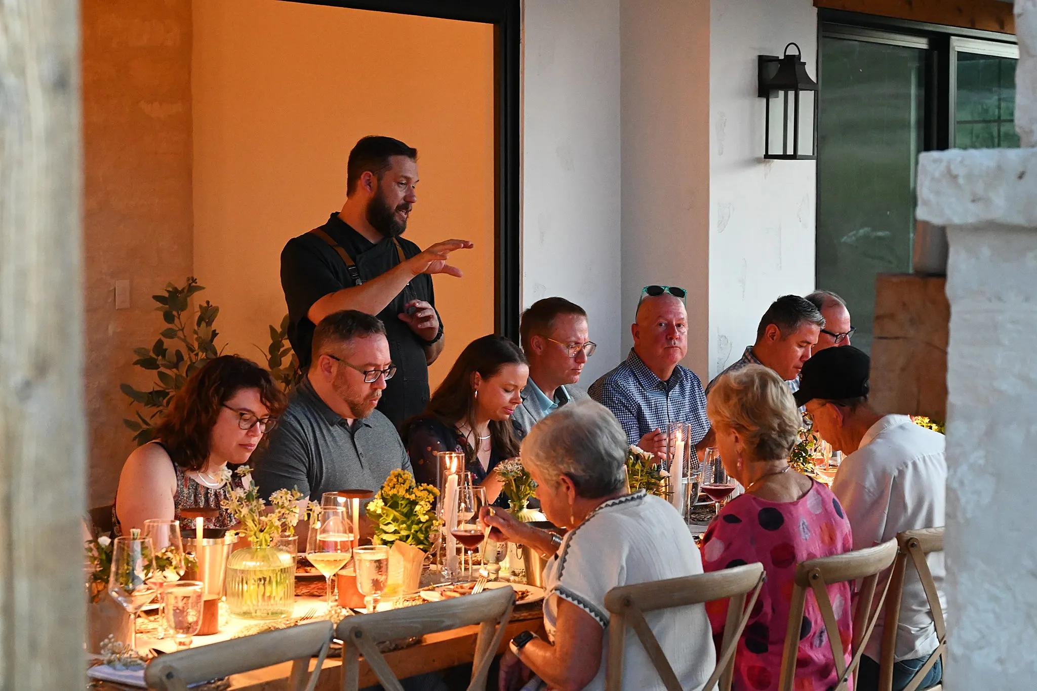 Chef presenting a course at the orchard supper club